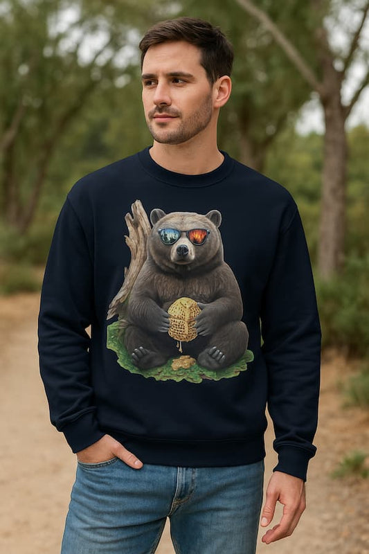 Man wearing a black sweatshirt with a bear graphic outdoors