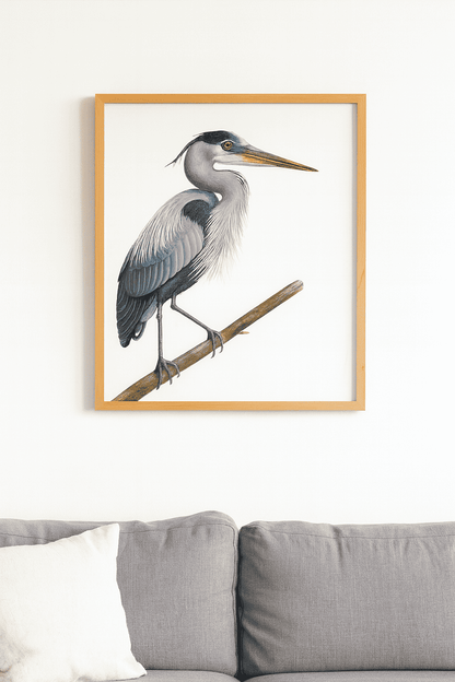 Framed artwork of a heron on a branch above a sofa