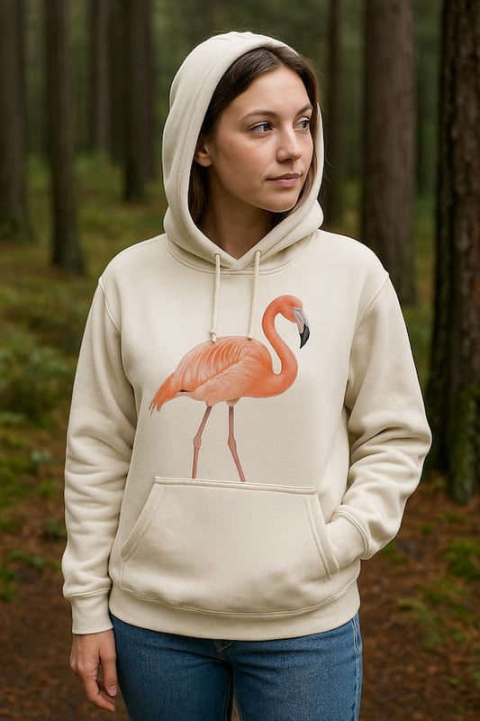 Woman wearing a beige hoodie with a flamingo design in a forest setting