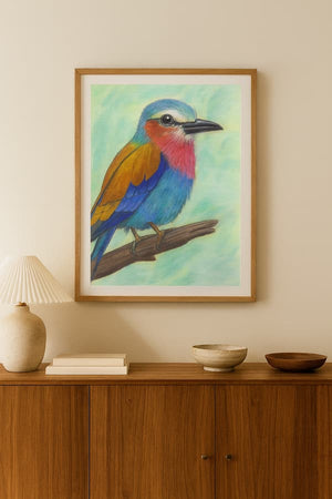 Framed artwork of a colorful bird on a wall above a wooden cabinet.