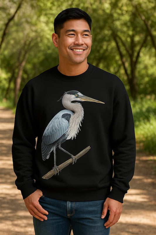 Man wearing a black sweatshirt with a heron design outdoors